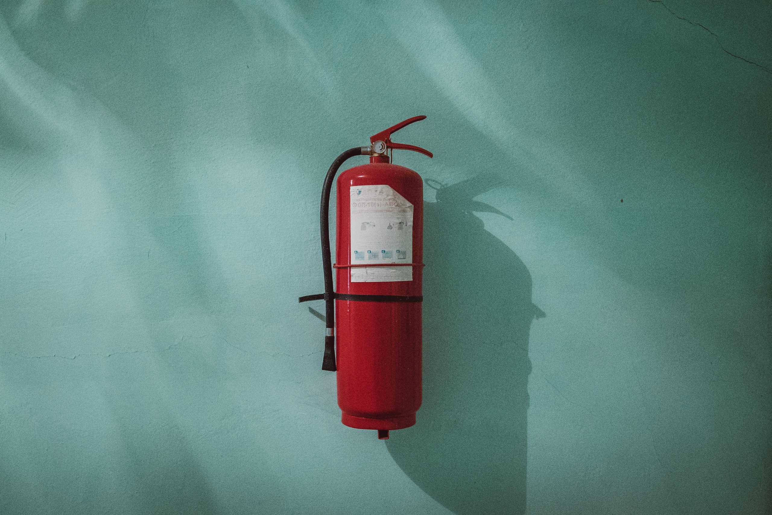 fire hydrant hanging on blue wall