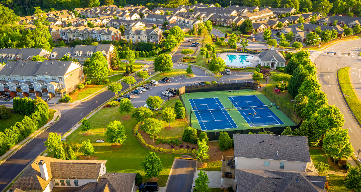 Aerial view of Central Florida residential community with HOA amenities including tennis courts and pool protected by Insyte Security intrusion detection and surveillance systems